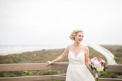 braided updo with medium length fingertip veil with lace