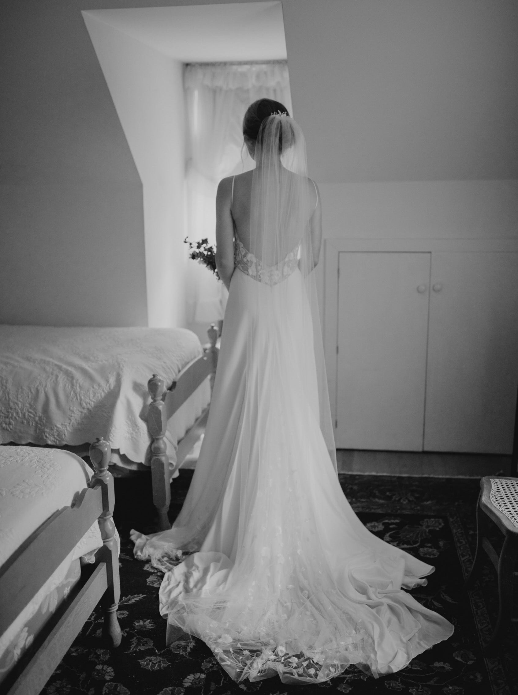 long cut edge bridal veil on bride with low scoop back gown