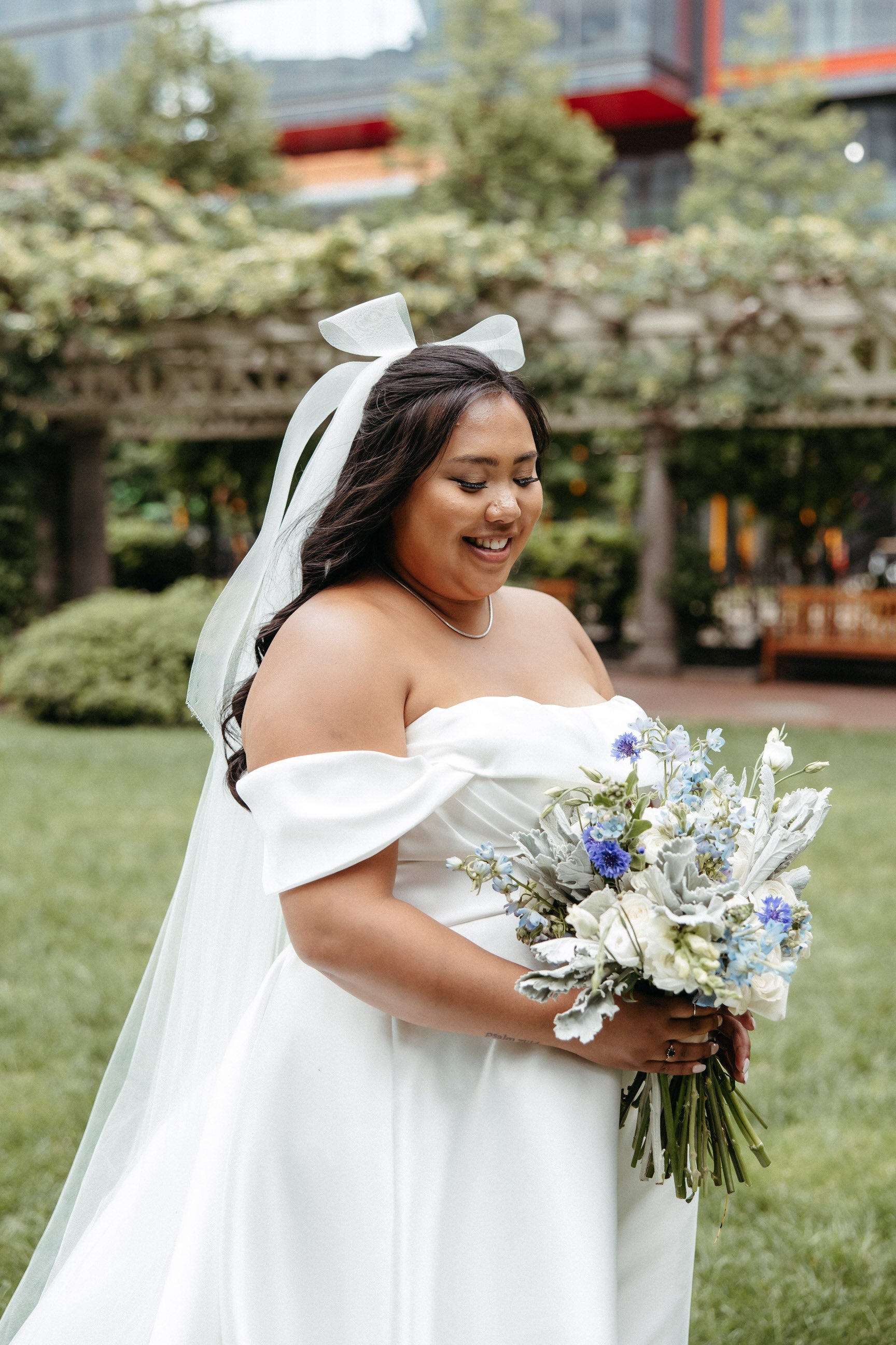beautiful plus sized bride with bridal hair bow and long cathedral veil