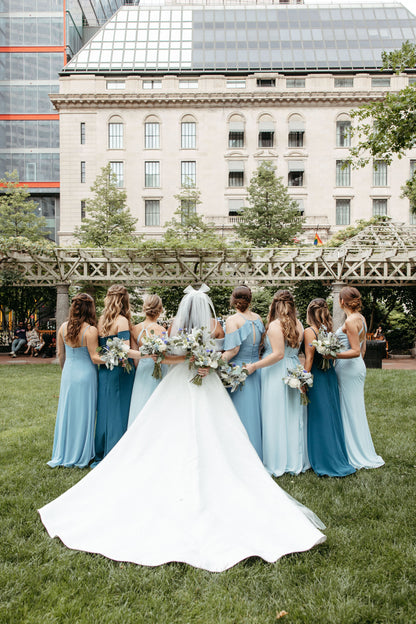 sheer wedding bow with tails on bride with light blue chiffon bridesmaids dresses