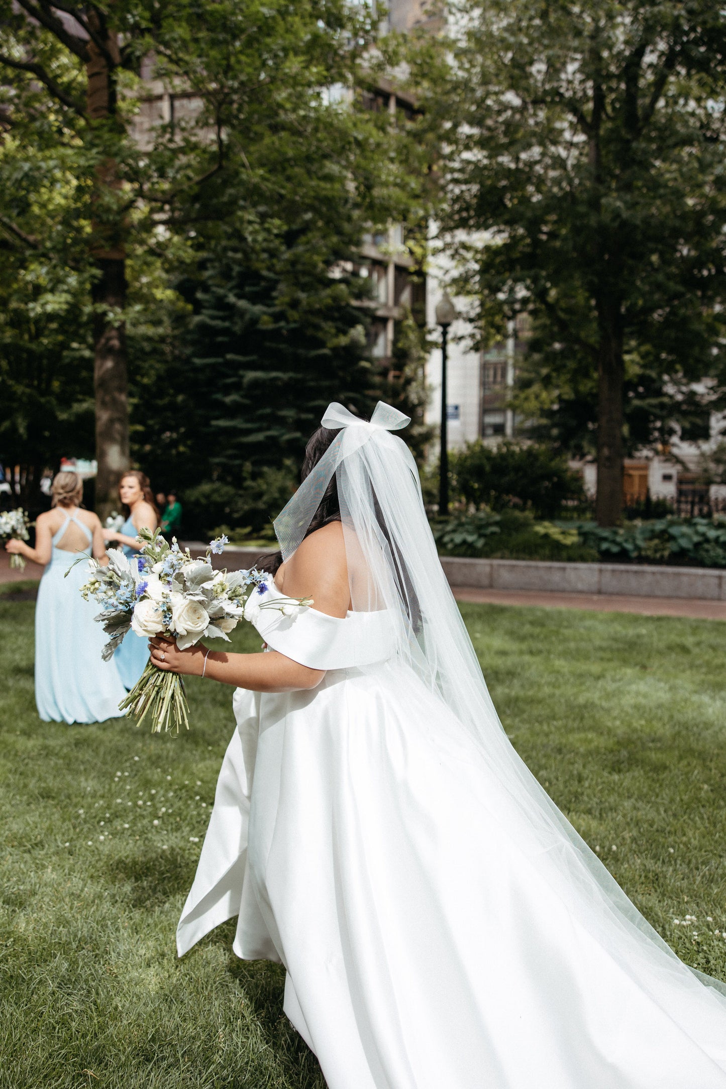 fun and vintage inspired bridal hair bow in bride's hair as she walks in long cathedral bridal veil