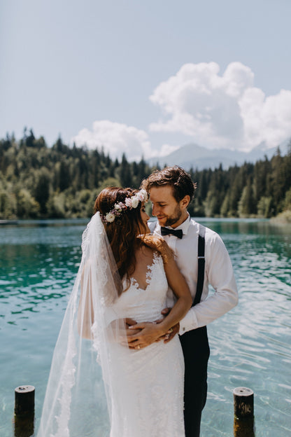 Natural lake wedding with bride in boho lace dress, hair wreath, and waltz length wedding veil