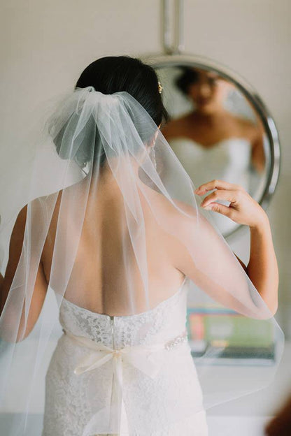 strapless wedding dress and sheer one tier short veil