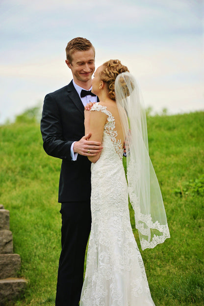 outdoor wedding with low back dress and lace bridal veil